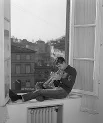 Jazz Improvisers - Chet Baker playing trumpet, sitting on a ...